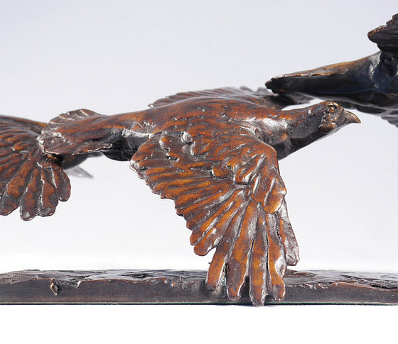 Three Grouse in Flight